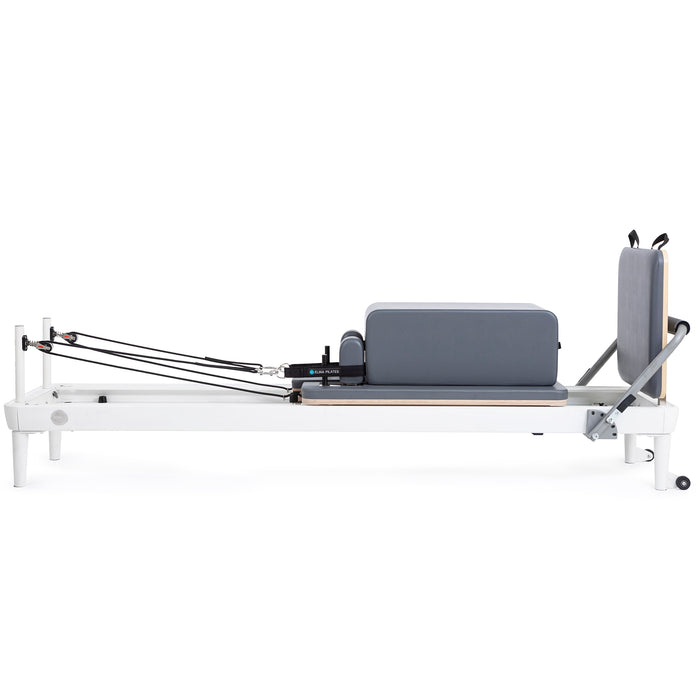 Elina Pilates Nubium reformer with a white aluminum frame, grey upholstery, sitting box and jumpboard, shown without a tower.