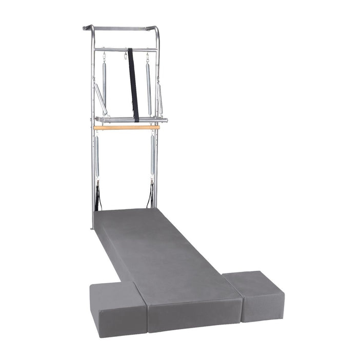 Elina Pilates Wall Unit with a stainless steel tower, springs, bars and a grey stationary mat, shown on a white background.