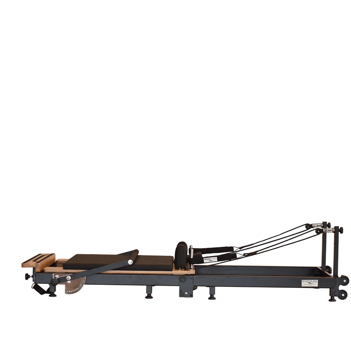 Space-saving Pilates reformer folded upright with wheels and locking system