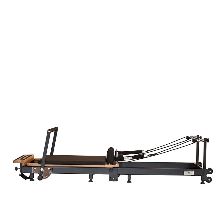 Space-saving Pilates reformer folded upright with wheels and locking system