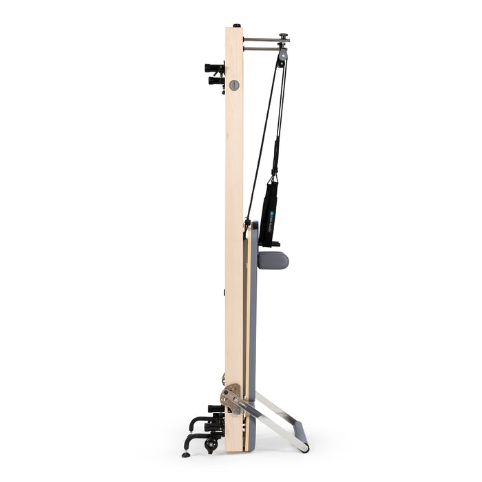 Compact vertical Pilates reformer with accessories

