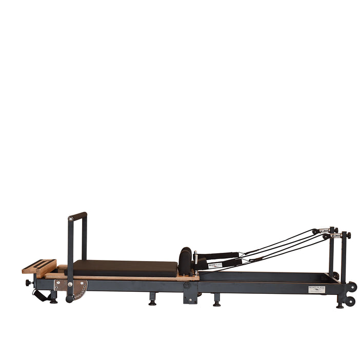 Space-saving Pilates reformer folded upright with wheels and locking system