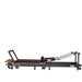 Portable Pilates reformer with adjustable footbar and ergonomic carriage