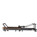 Portable Pilates reformer with adjustable footbar and ergonomic carriage