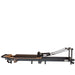 Portable Pilates reformer with adjustable footbar and ergonomic carriage