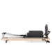 Compact vertical Pilates reformer with accessories

