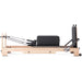 Elina Pilates Lignum Reformer Bundle - in-use shot demonstrating Pilates exercise on wood reformer