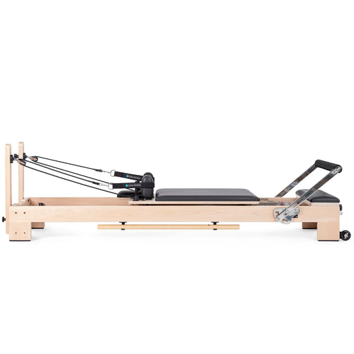 Elina Pilates Lignum Reformer Bundle - side view showing natural wood finish and included bundle accessories