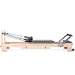 Elina Pilates Lignum Reformer Bundle - side view showing natural wood finish and included bundle accessories