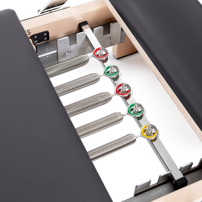 Elina Pilates Lignum Reformer with Tower - angled view highlighting solid wood frame craftsmanship