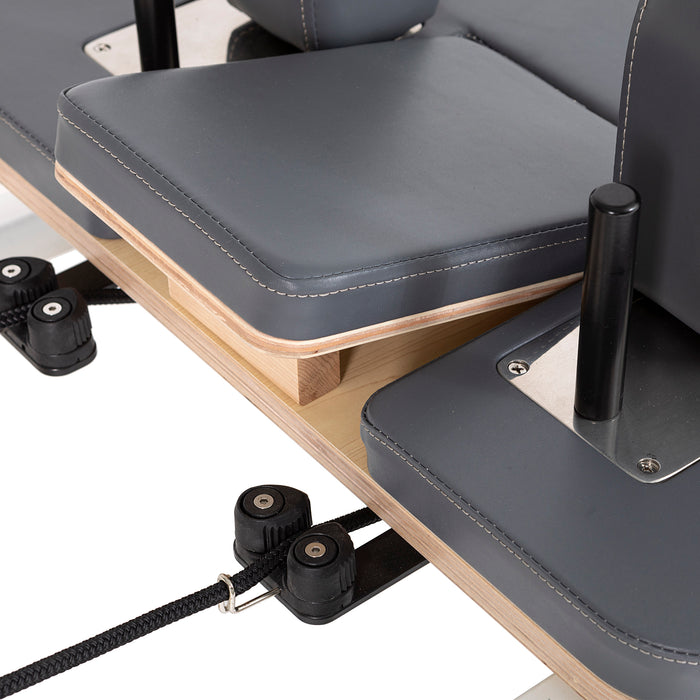 Elina Pilates Lignum Reformer with Tower - close-up detail of natural wood grain and reformer carriage