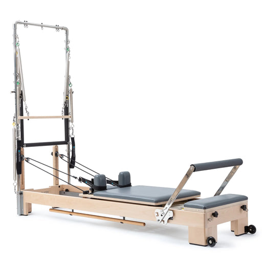 Elina Pilates Lignum Reformer with Tower - side view showing natural wood finish and tower height