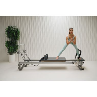Elina Pilates Mentor Reformer Bundle - second in-use shot showing leg press exercise on mentor reformer
