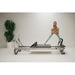 Elina Pilates Mentor Reformer Bundle - second in-use shot showing leg press exercise on mentor reformer