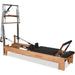 Pilates reformer with tower springs, footbar, and orthopedic sitting box