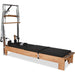 Pilates reformer with tower springs, footbar, and orthopedic sitting box