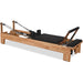 Beechwood Pilates reformer with chrome components and padded platform

