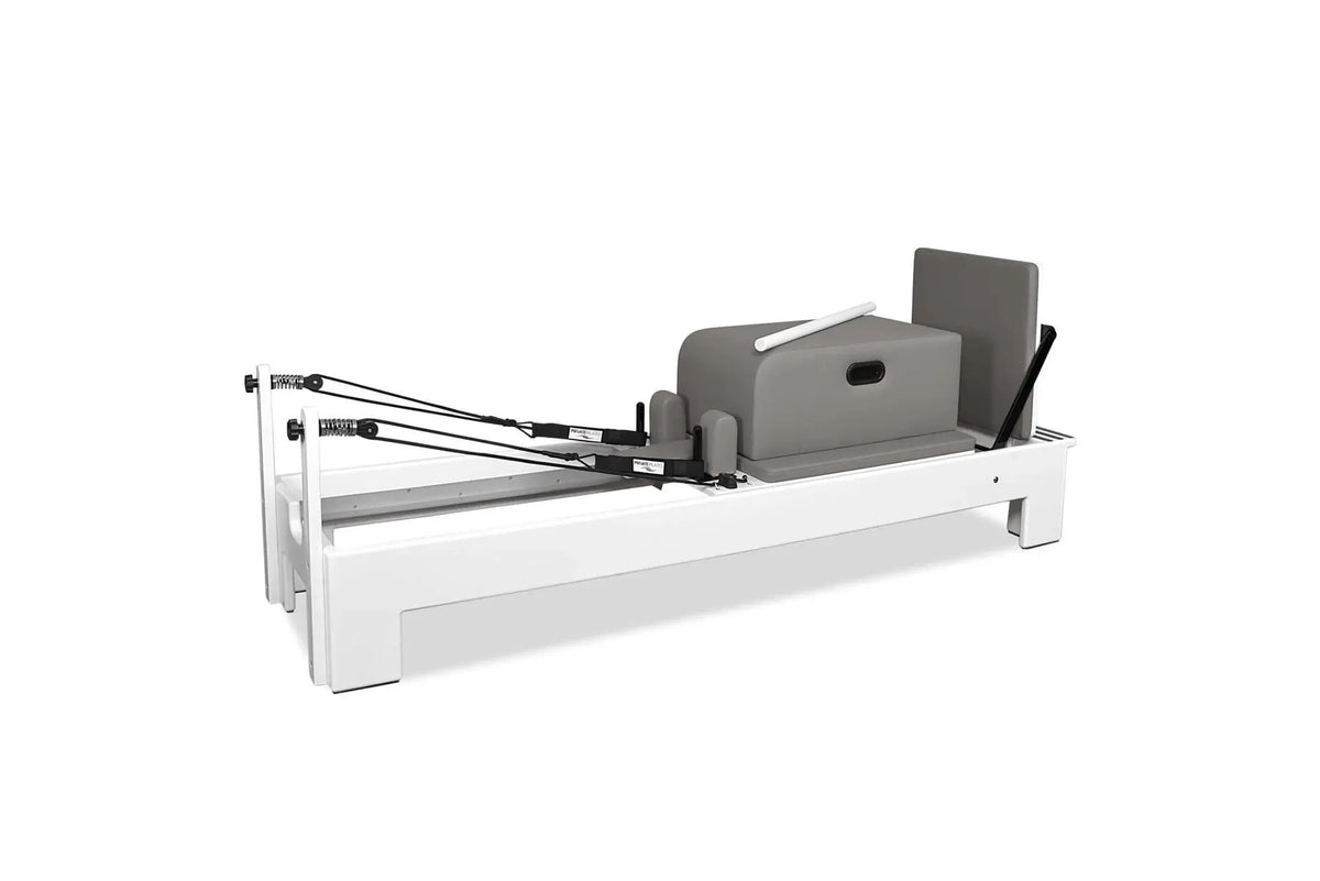 Private Pilates Elite Wood Reformer with white frame and gray upholstery