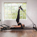 Woman Exercising on Align-Pilates R8-Pro Pilates Reformer Black