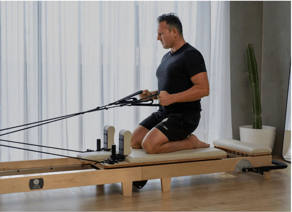 The Core Collab Foldable Pilates Reformer Eco - folded compact position showing space-saving design for home storage