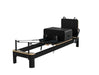 The Core Collab Queen Studio Pilates Reformer - front view showing complete reformer frame and footbar