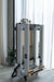 TCC Queen Foldable Pilates Reformer - side profile showing folding hinge mechanism and compact storage position