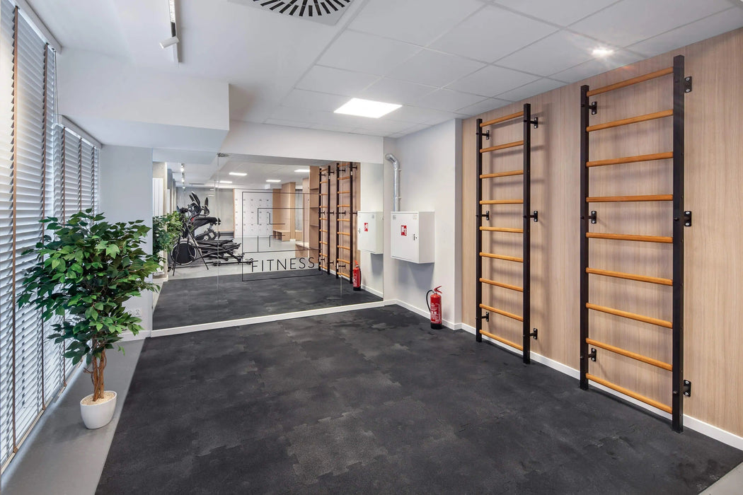 BenchK 700B Black wall bars installed in a training space