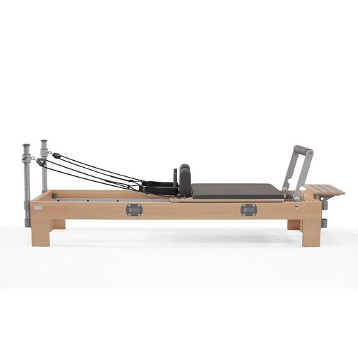 BASI Systems Compact Reformer - side view showing carriage, springs, and adjustable footbar